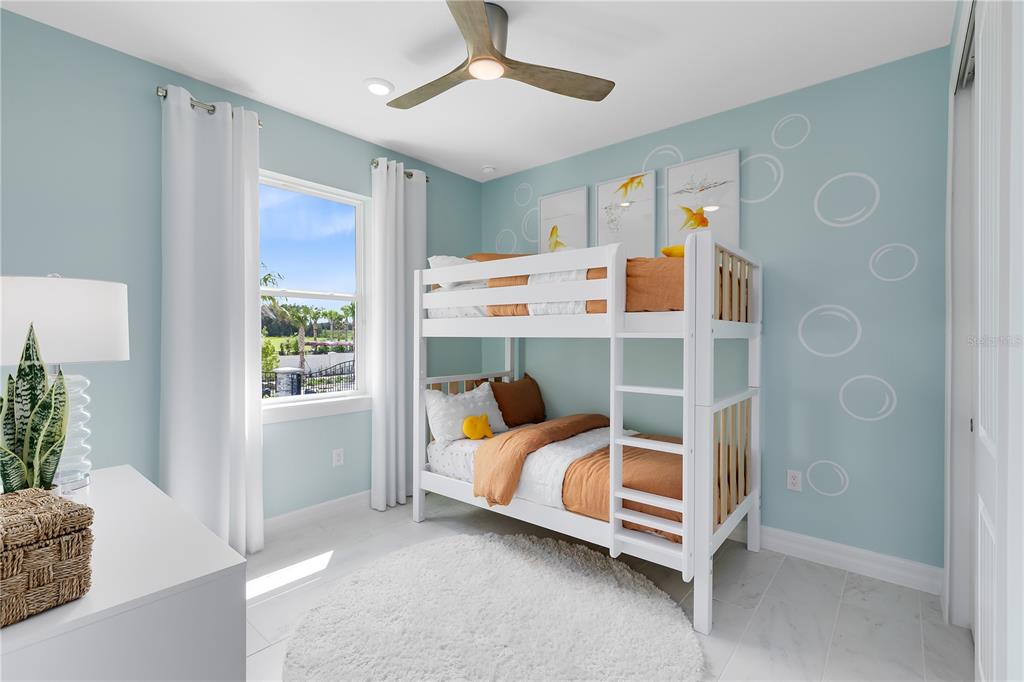 A bedroom features a white bunk bed, light blue walls with bubble decals, and a window — 5243 HANDSOME HILLS DRIVE, MOUNT DORA, FL