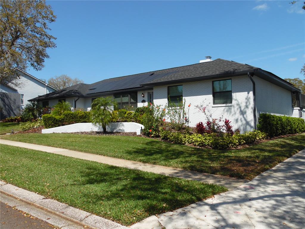A single-story white brick house with a dark roof and landscaped front yard — 2709 FAIRWAY VIEW DRIVE, VALRICO, FL