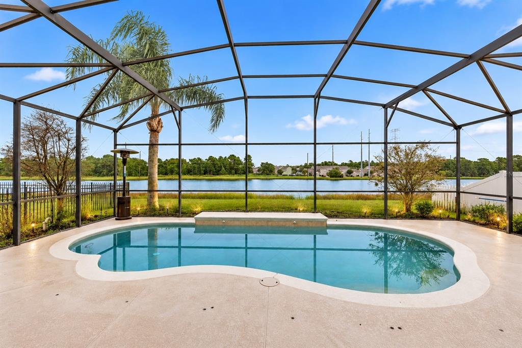 An aerial view of a two-story house with a screened-in pool and backyard — 14585 CHEEVER STREET, ORLANDO, FL