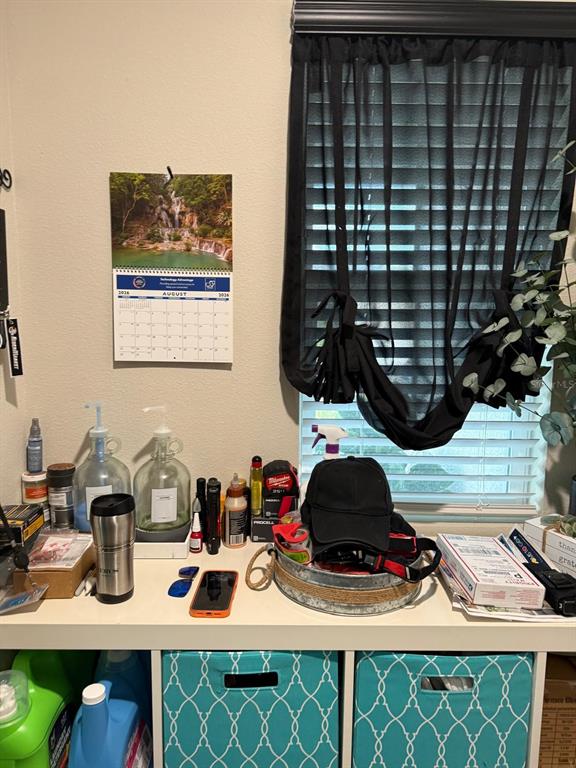 A desk area features a calendar, various bottles, a black hat, and teal storage bins below — 5508 MADDIE DRIVE, HAINES CITY, FL