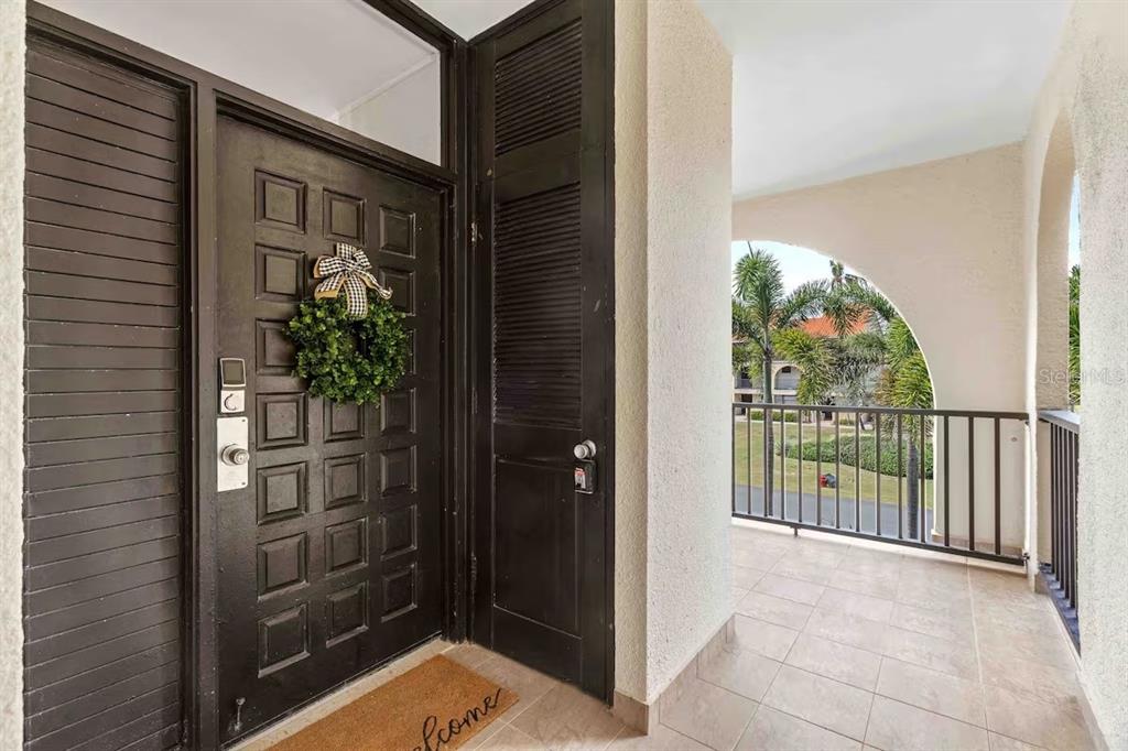 A modern kitchen features white cabinets, light wood accents, stainless steel appliances, and quartz countertops — DR BEACH VILLAGE UNIT 148, HUMACAO, PR