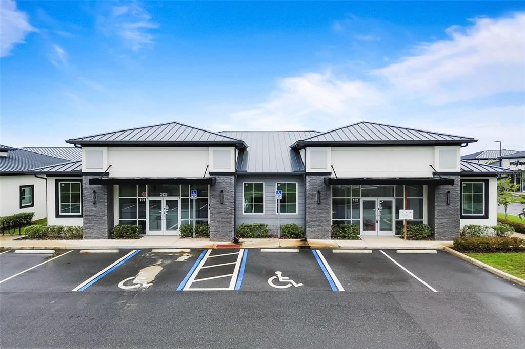 A single-story commercial building with two glass-fronted entrances and a paved parking lot — 2623 S US HIGHWAY 27, CLERMONT, FL