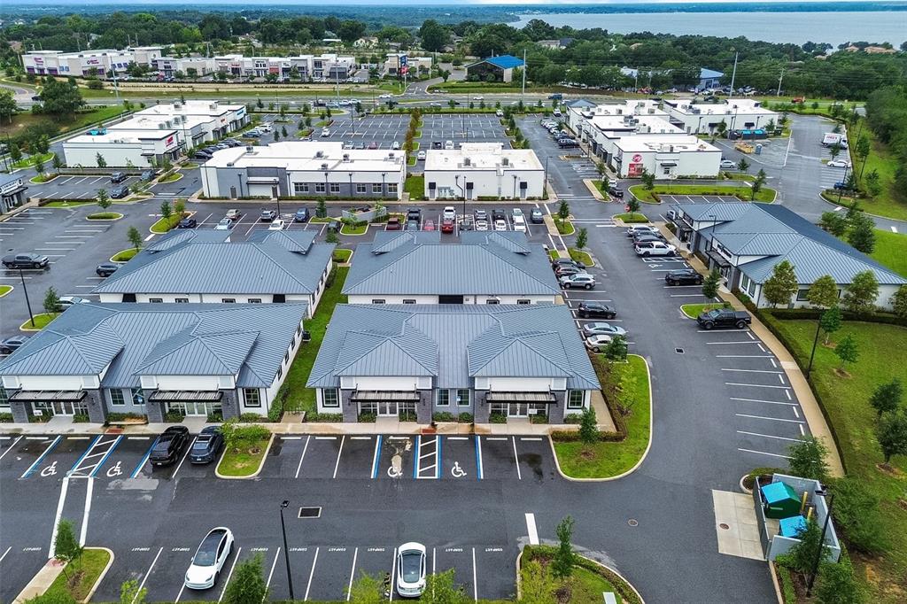 An aerial view shows a commercial office park with multiple buildings and a parking lot — 2623 S US HIGHWAY 27, CLERMONT, FL