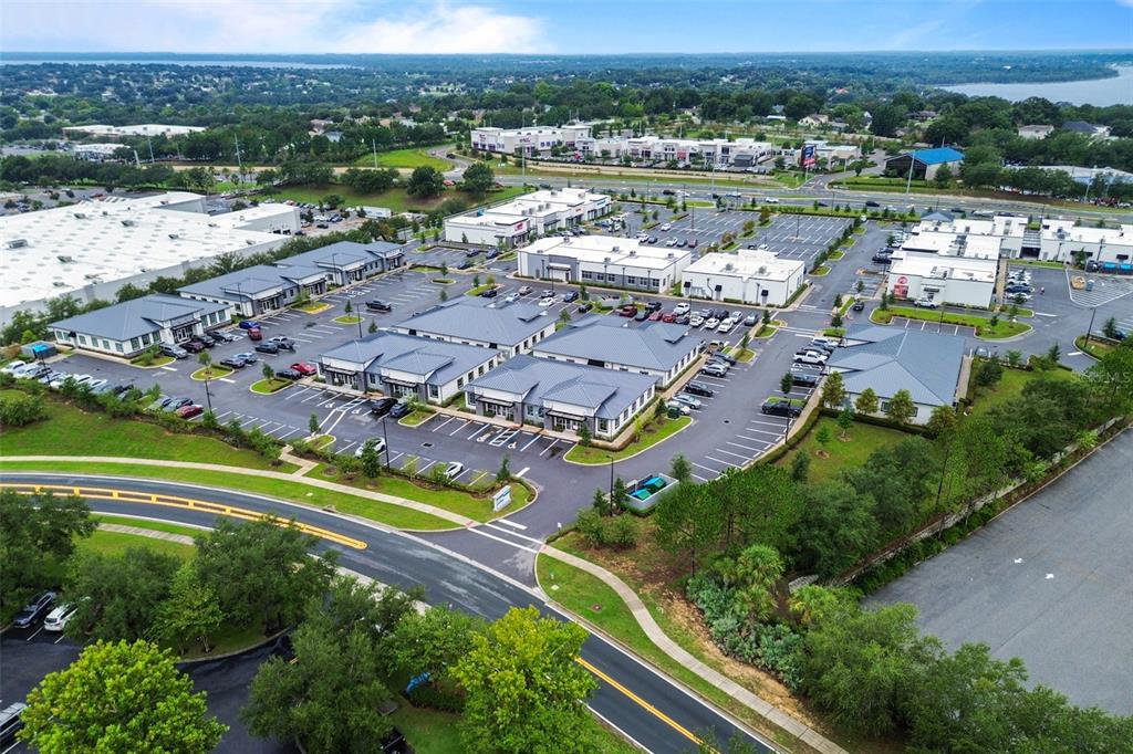 An aerial view shows a commercial office park with multiple buildings, parking lots, and landscaping — 2623 S US HIGHWAY 27, CLERMONT, FL