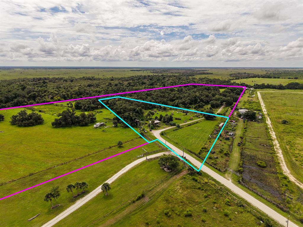 An aerial view shows a rural property with outlined boundaries, pasture, trees, and a driveway — 16501 COKER GULLY ROAD, MYAKKA CITY, FL