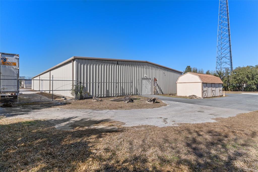 A metal warehouse building stands next to a small shed and a tall radio tower — 6331 & 6275 S TEX POINT, HOMOSASSA, FL