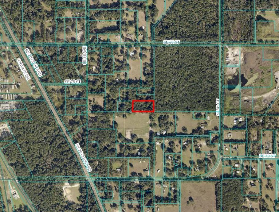 An aerial map shows a rectangular parcel of land highlighted in red within a wooded area — UNDETERMINED, OCALA, FL