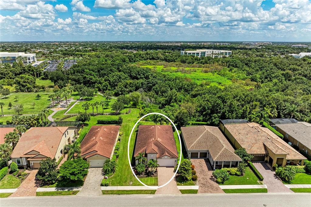 An aerial view shows a suburban house with a tiled roof circled in a residential neighborhood — 4645 ROYAL DORNOCH CIRCLE, BRADENTON, FL