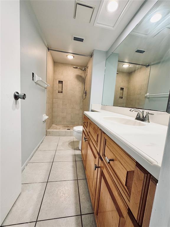 A bathroom features a wooden vanity, a large mirror, a tiled floor, and a walk-in shower — 106 WINDWARD PLACE, OLDSMAR, FL