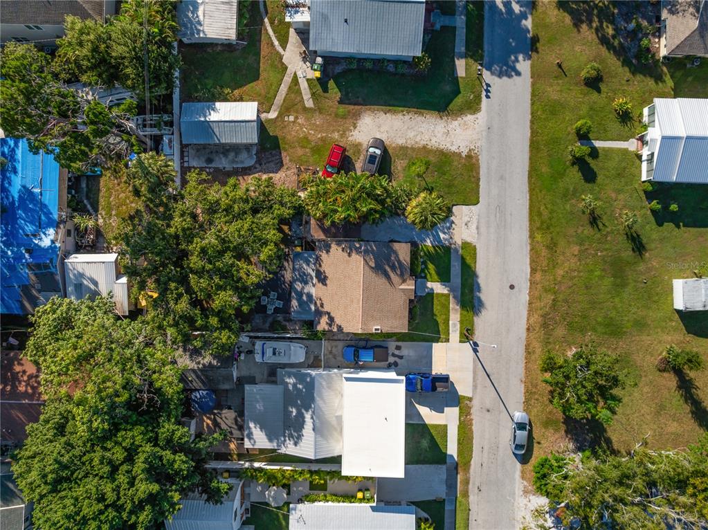 An aerial view shows a residential property with a house, outbuildings, and vehicles parked nearby — 2530 LOMA LINDA STREET, SARASOTA, FL