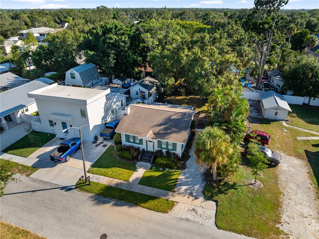 An aerial view shows a single-story house with a driveway, adjacent structures, and surrounding trees — 2530 LOMA LINDA STREET, SARASOTA, FL