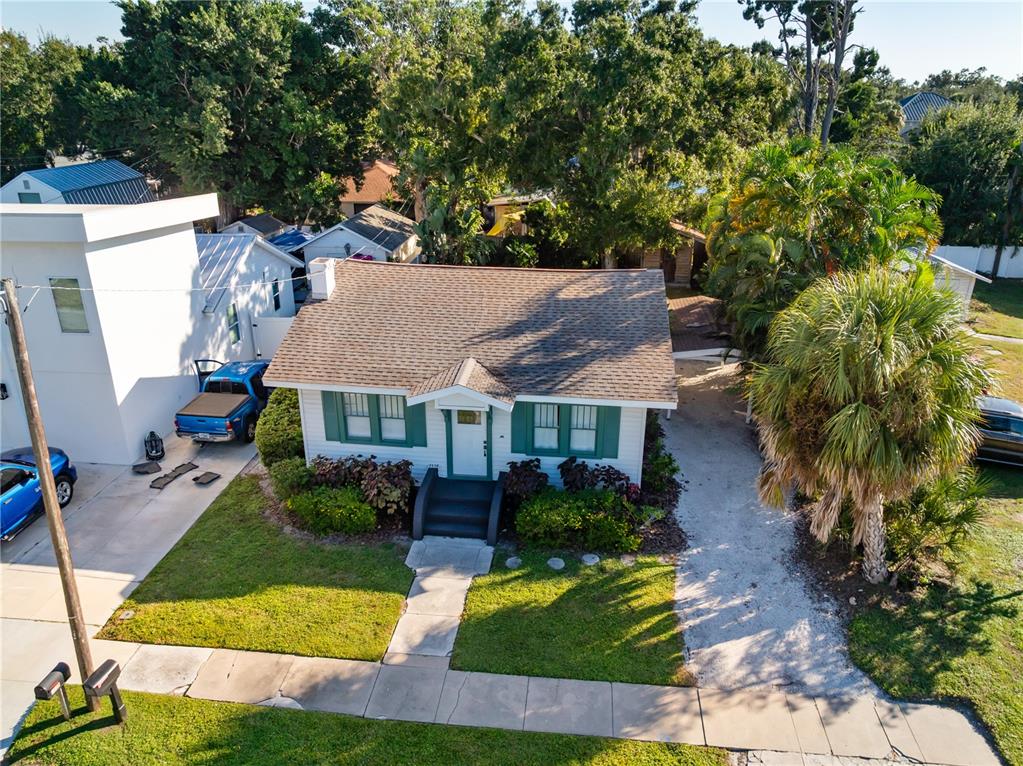 An aerial view shows a single-story house with a shingled roof and green shutters — 2530 LOMA LINDA STREET, SARASOTA, FL
