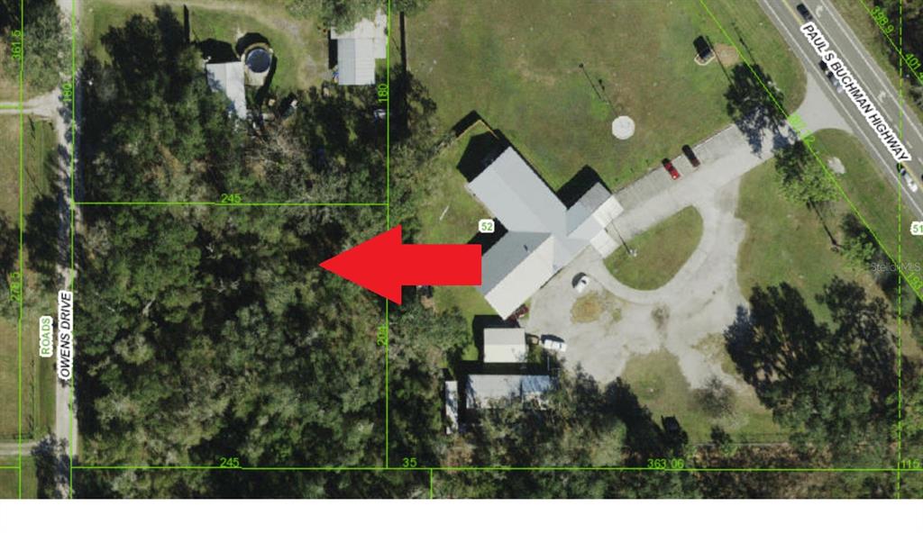 This is an aerial map showing a property with a building and surrounding wooded land — null OWENS DRIVE, ZEPHYRHILLS, FL