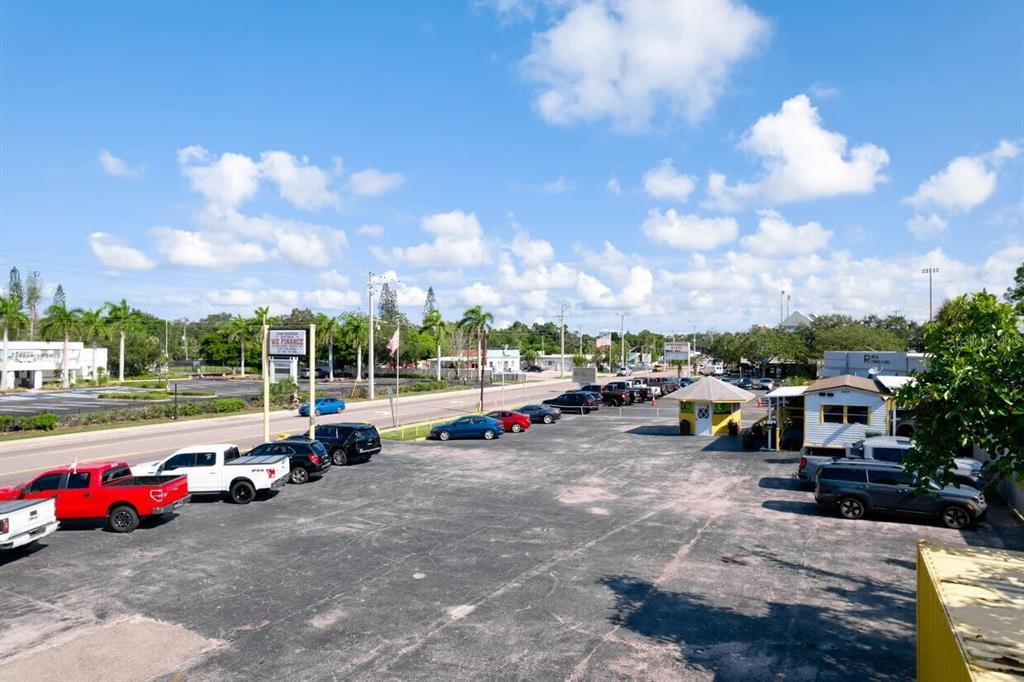 An elevated view of a car dealership lot with parked vehicles and a small office building — 1827 9TH STREET W, BRADENTON, FL