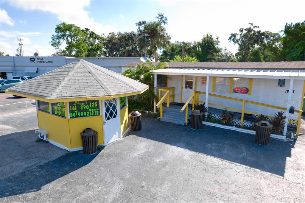 An exterior view shows a yellow gazebo and a white office building with yellow trim — 1827 9TH STREET W, BRADENTON, FL