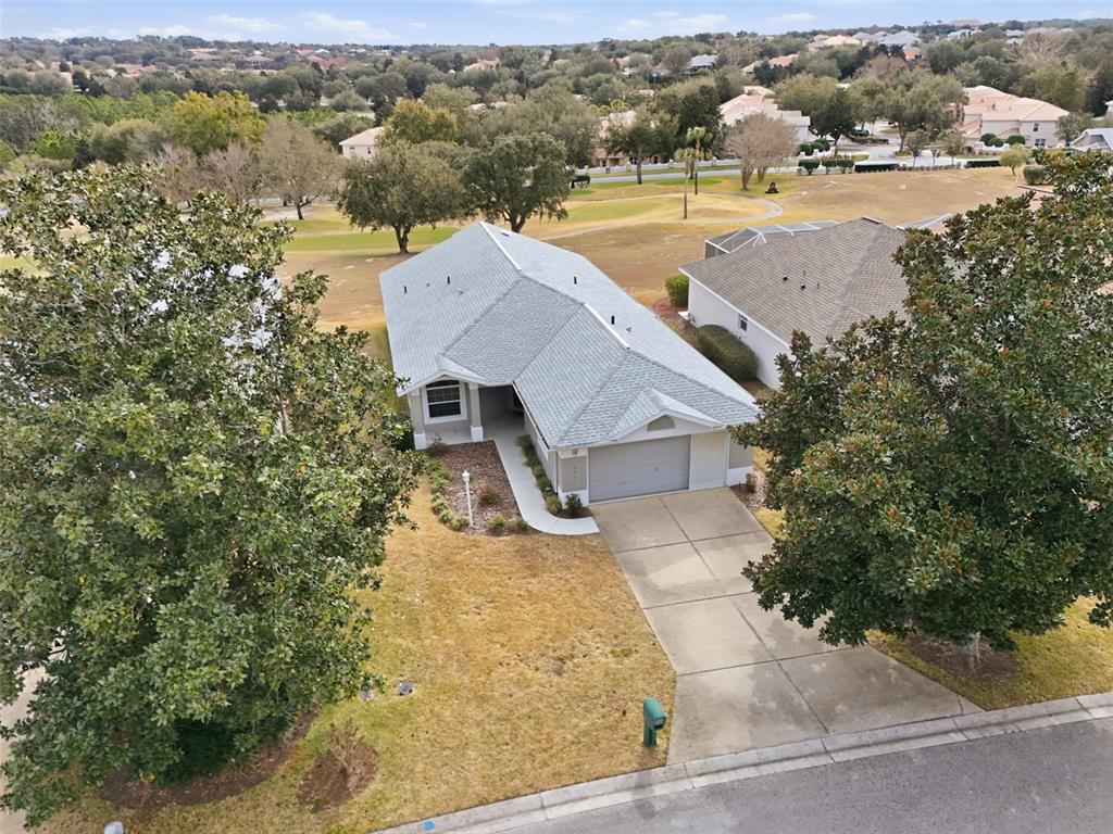 An aerial view shows a single-story house with a gray roof and concrete driveway — 2311 N ANDREA POINT, LECANTO, FL