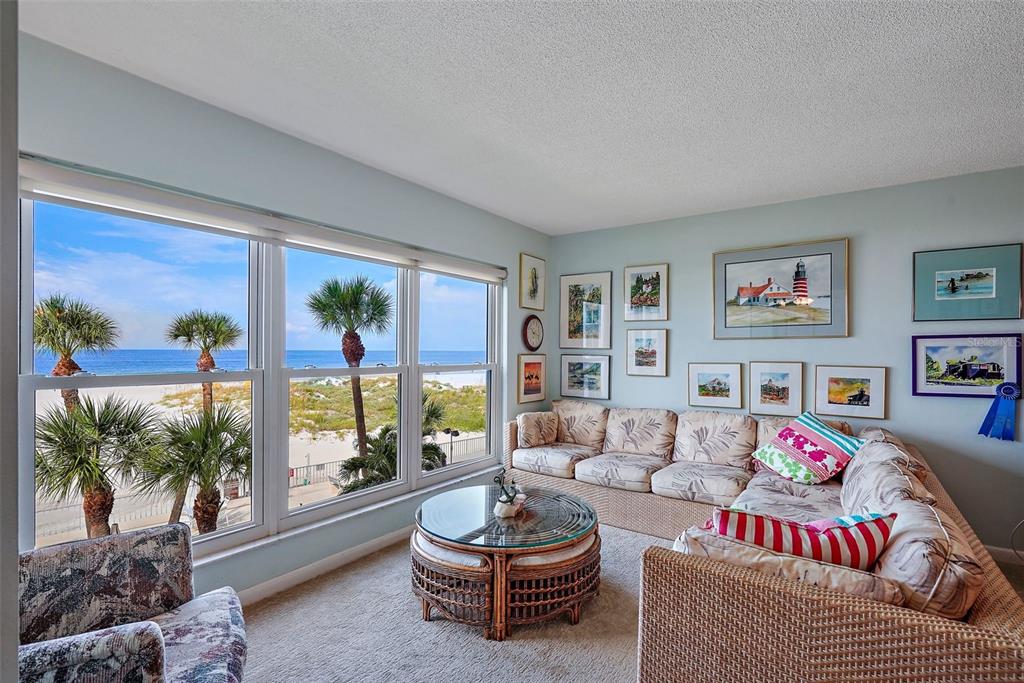 A view of a sandy beach and ocean through a white-framed window — 5000 GULF BOULEVARD UNIT 304, ST PETE BEACH, FL