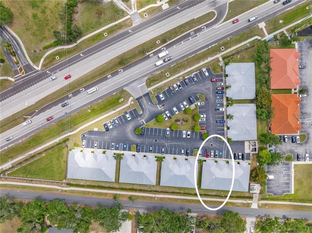 Aerial view of a commercial building complex with a parking lot and surrounding roads — 436 S TAMIAMI TRAIL UNIT C4, OSPREY, FL