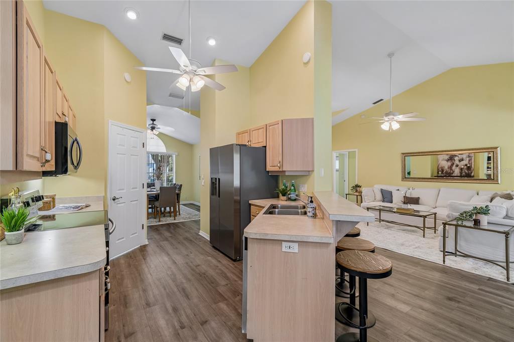 A yellow single-story house with a concrete driveway and a two-car garage — 12728 FLAMINGO PARKWAY, SPRING HILL, FL