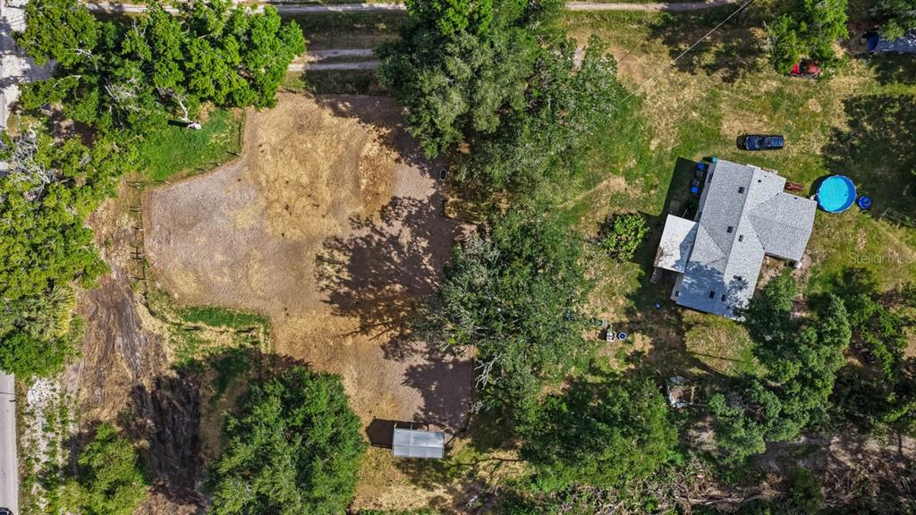 An aerial view shows a house with a pool next to a large, cleared dirt lot — 5614 WATSON ROAD, RIVERVIEW, FL