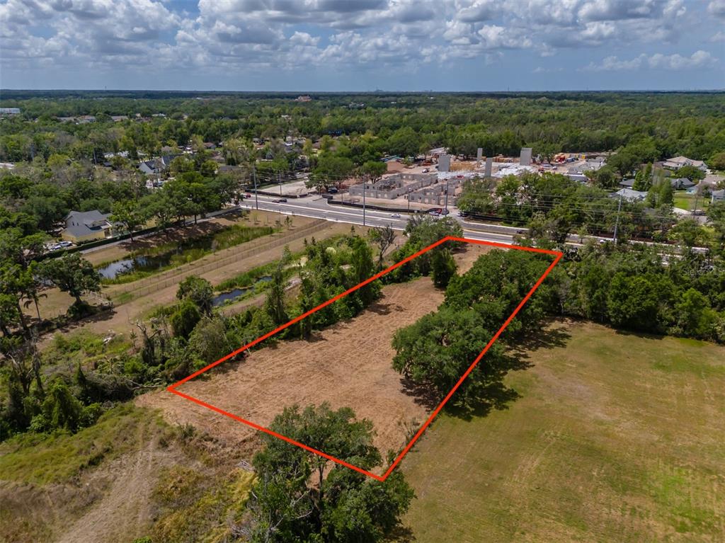 An aerial view shows a rectangular plot of land outlined in red near a road — 5106 BELL SHOALS ROAD, VALRICO, FL