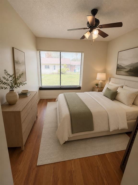 A bedroom with a bed, dresser, ceiling fan, and window overlooking a residential neighborhood — 11 TROPHY LANE, KISSIMMEE, FL