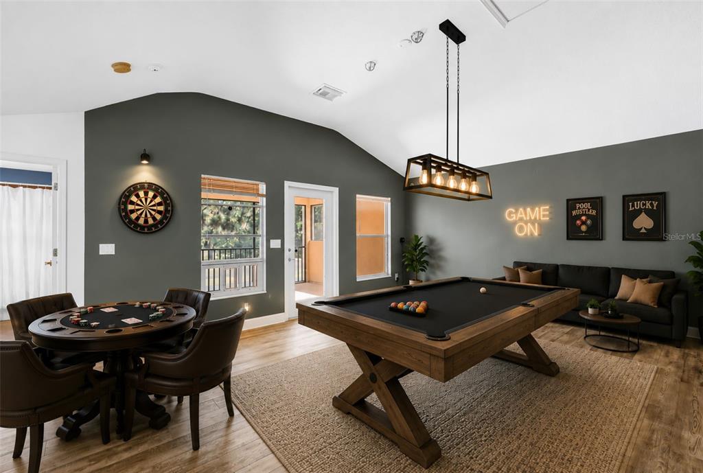 A kitchen with wood cabinets, granite countertops, and a stainless steel dishwasher overlooks a pool — 27405 SORA BOULEVARD, WESLEY CHAPEL, FL