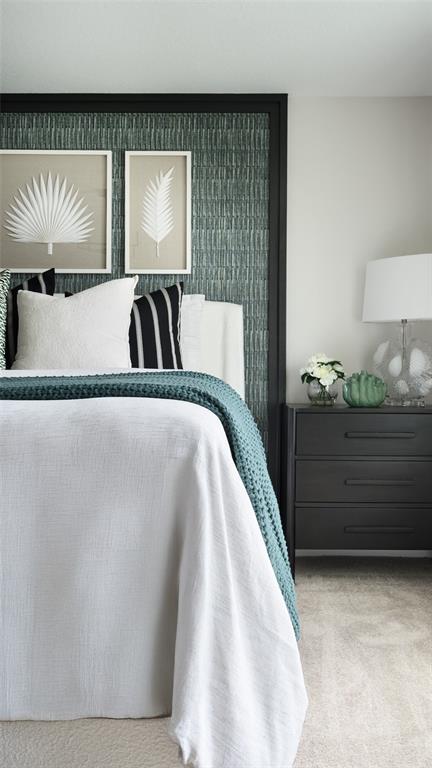 A bedroom features a bed with a teal textured headboard, white bedding, and a black nightstand — 1747 VANILLA STREET, HAINES CITY, FL