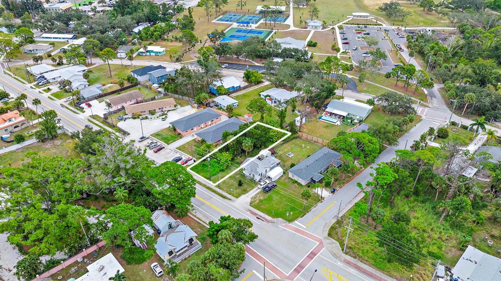 An aerial view shows a residential property with a highlighted lot near a street intersection — COLONIA LANE, NOKOMIS, FL
