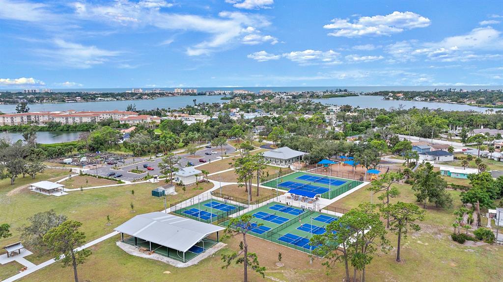 An aerial view shows a public park with tennis courts, a pavilion, and a parking lot — COLONIA LANE, NOKOMIS, FL