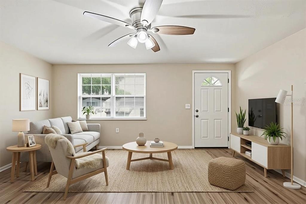 This is a virtually staged living room with light wood flooring and a ceiling fan — 3319 CANTRELL STREET, HOLIDAY, FL