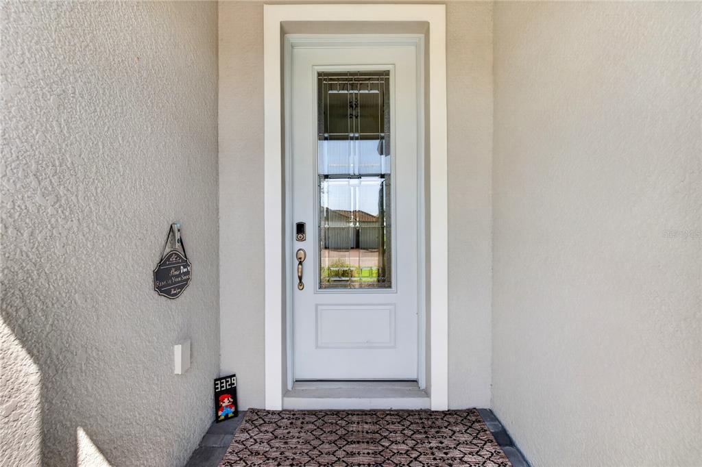 A front entryway features a white door with a glass insert and a patterned rug — 3329 BIG SKY WAY, LAKEWOOD RANCH, FL