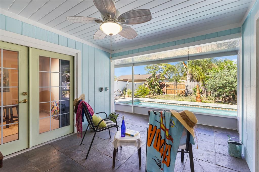 A backyard features a rectangular swimming pool surrounded by a paver patio and white fencing — 6609 MAUNA LOA BOULEVARD, SARASOTA, FL