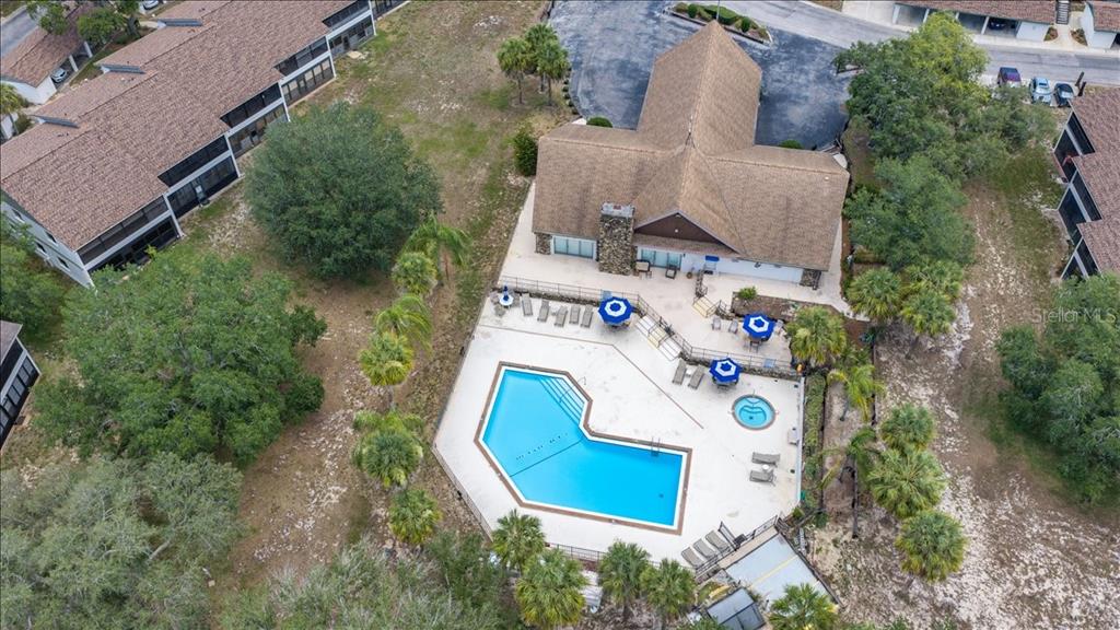 A two-story apartment building features a balcony with black railings and a palm tree — 6653 RIVER RUN BOULEVARD, WEEKI WACHEE, FL