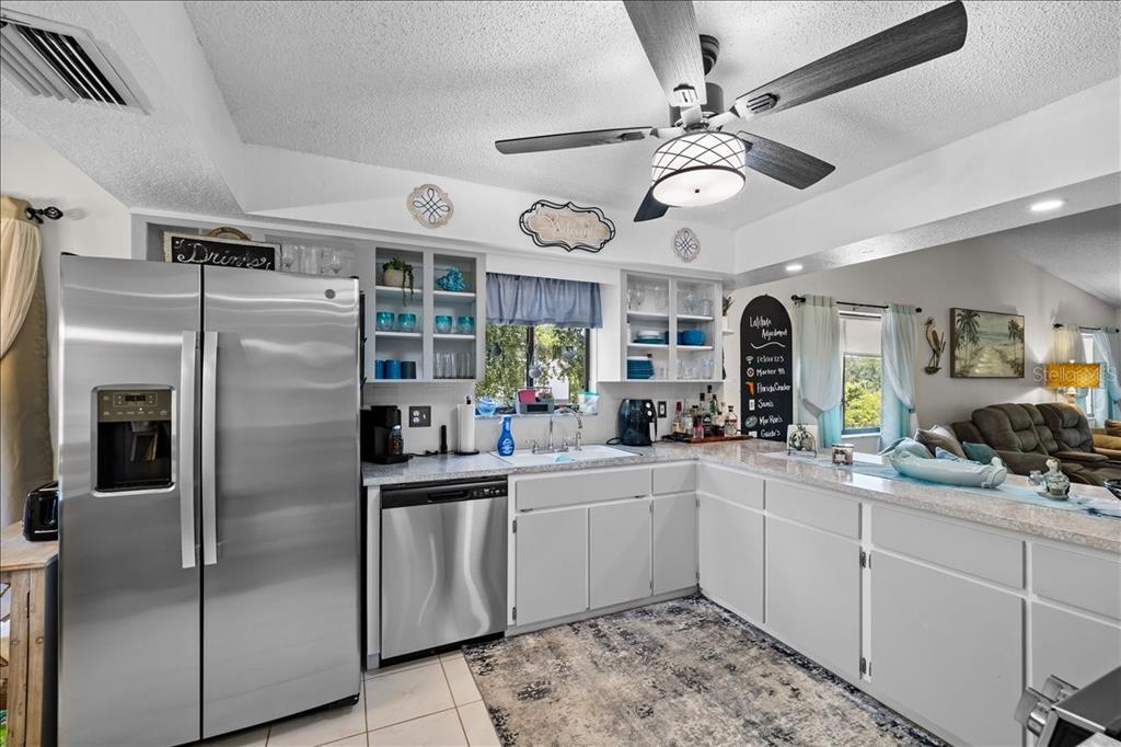 An aerial view shows a community clubhouse with a swimming pool and hot tub — 6653 RIVER RUN BOULEVARD, WEEKI WACHEE, FL