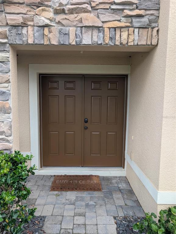 A brown double front door with a stone facade and a paver entryway — 2979 ETOWAH PARK BOULEVARD, TAVARES, FL