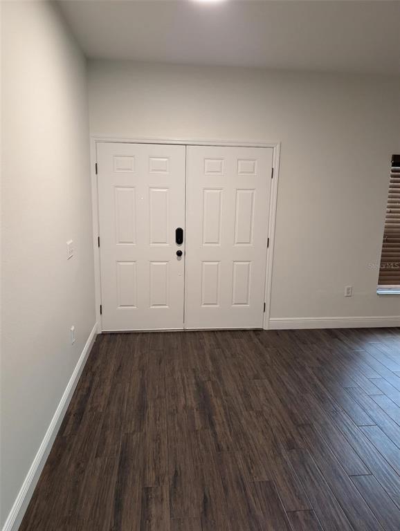A room with dark wood-look flooring and white double doors — 2979 ETOWAH PARK BOULEVARD, TAVARES, FL