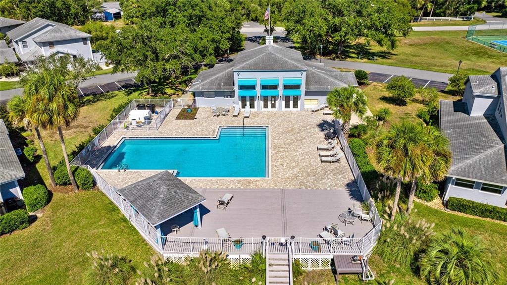 An aerial view shows a swimming pool with a deck, gazebo, and adjacent clubhouse building — 11043 W HARBOR WATCH LOOP, CRYSTAL RIVER, FL