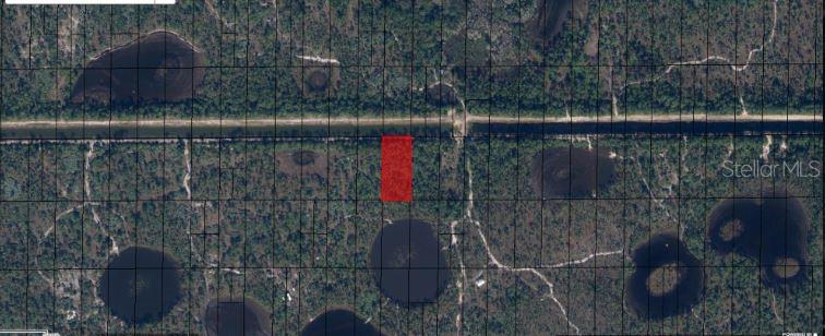 This aerial map shows a rectangular parcel of land highlighted in red along a canal — N/A, INDIANTOWN, FL