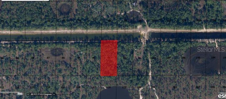 This aerial map shows a rectangular parcel of land highlighted in red near a canal — N/A, INDIANTOWN, FL