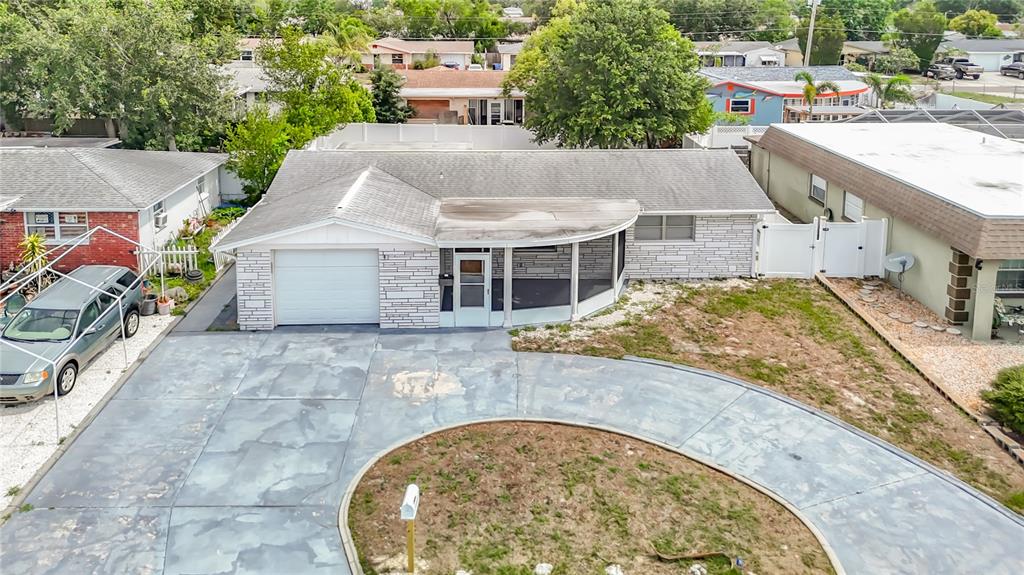 An aerial view of a single-story house with a circular driveway and a front porch — 3441 EISENHOWER DRIVE, HOLIDAY, FL
