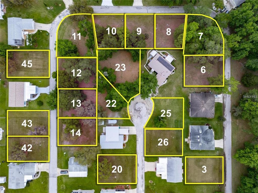 This is an aerial map showing numbered residential land parcels and existing houses — LOT 26 BLK D STRATFORD COURT, WILDWOOD, FL