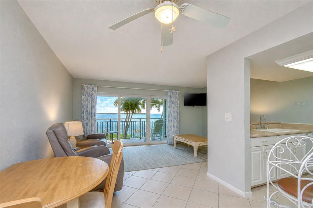 A hallway with tile floors leads to a bathroom, a bedroom, and an entry door — 200 1ST AVENUE UNIT 207, ST PETE BEACH, FL