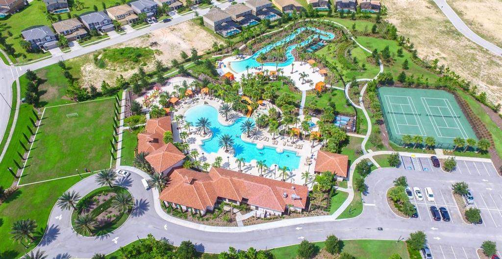 Aerial view of a community recreation center featuring a large swimming pool, lazy river, and tennis courts — 1307 OAK CREST STREET, DAVENPORT, FL