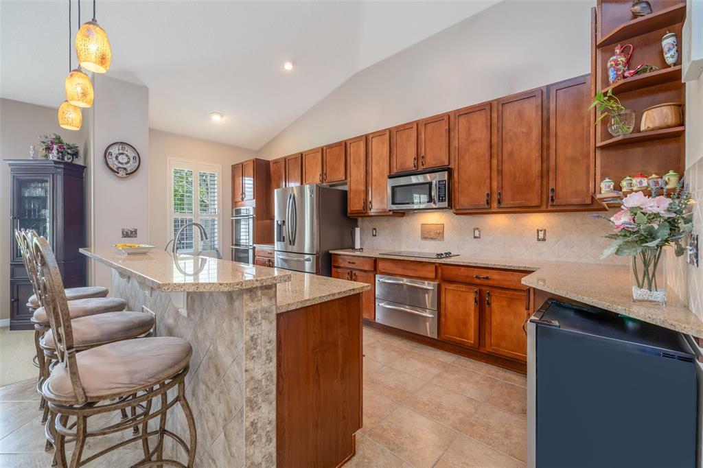 A foyer features a blue painted cabinet, tile flooring, a white door, and hanging lights — 61 RAINTREE CIRCLE, PALM COAST, FL