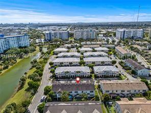 An aerial view shows a multi-story residential complex with a red marker on one building — 3953 BLACK OLIVE LANE, HOLLYWOOD, FL