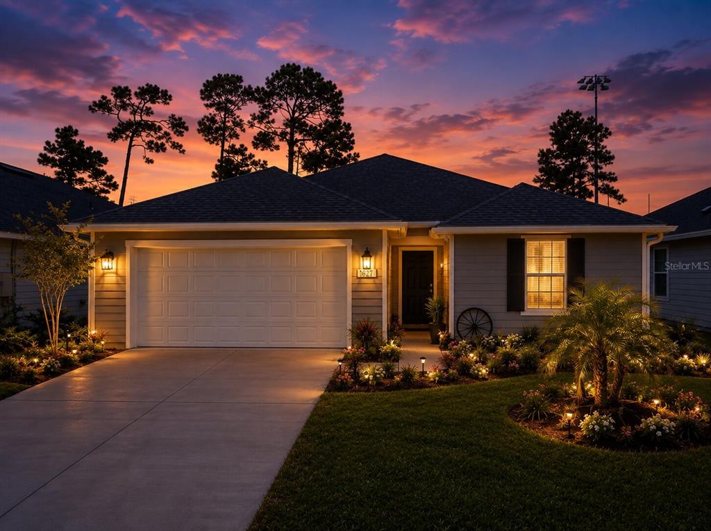 A modern kitchen features gray cabinets, a white island, stainless steel appliances, and blue backsplash — 7 SIGNET COURT, FLAGLER BEACH, FL