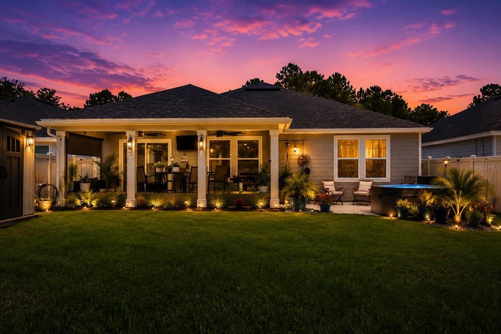 A covered patio features a ceiling fan, outdoor furniture, a television, and a Blackstone grill — 7 SIGNET COURT, FLAGLER BEACH, FL