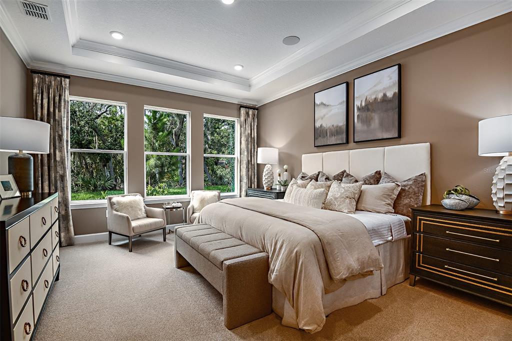 A living room features a beige sofa, two armchairs, a round coffee table, and a television — 19354 LOCHSIDE LANE, MOUNT DORA, FL
