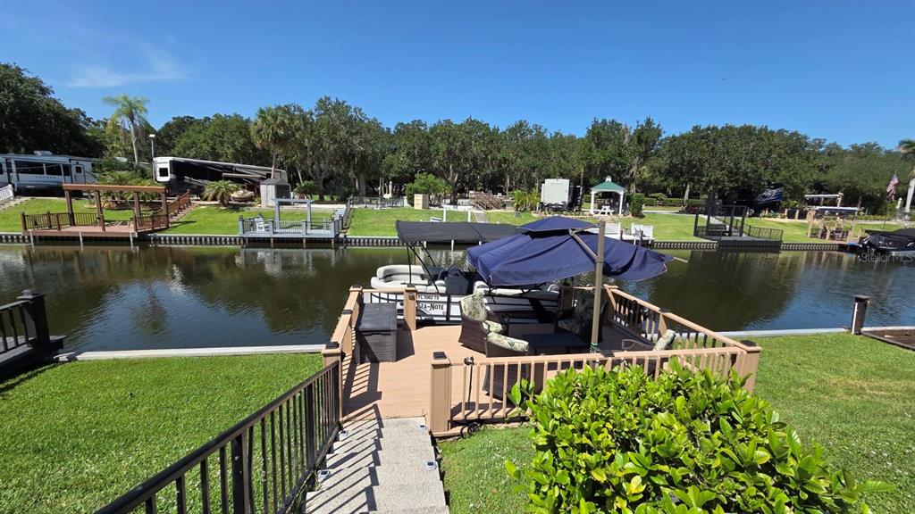 A Jayco travel trailer is parked on a concrete patio with its awning extended — 579 WATERWAY DRIVE, RIVER RANCH, FL